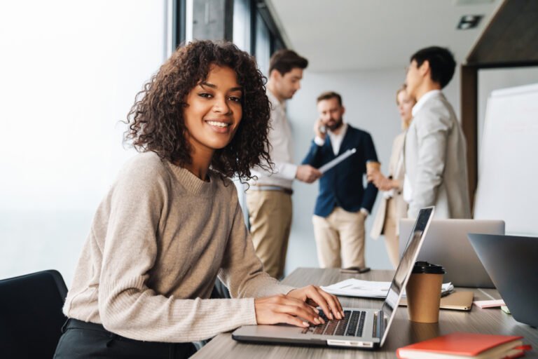 Smiling professional at a laptop, representing career guidance for working abroad