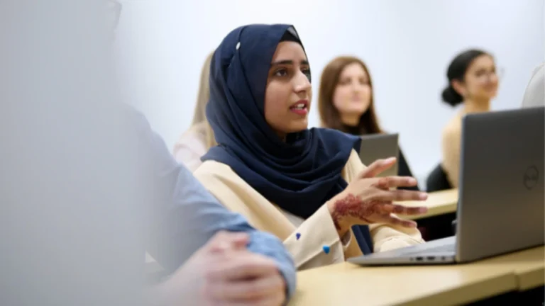 Professional woman in a team meeting, representing work visa support for moving abroad